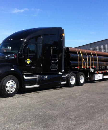 Eclipse Transport Ltd black truck transporting iron rods and steels.